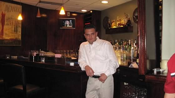 Martin Gjurashaj in a white shirt at the bar